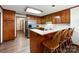 Traditional kitchen features wood cabinets, breakfast bar with seating and stainless steel refrigerator at 965 Hunting Ave, Lincolnton, NC 28092