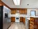 Kitchen featuring stainless steel appliances, laminate countertop, and natural wood cabinets at 965 Hunting Ave, Lincolnton, NC 28092