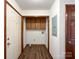 A well lit laundry room featuring wood cabinets and linoleum floors at 965 Hunting Ave, Lincolnton, NC 28092