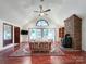 Spacious living room with vaulted ceiling, brick fireplace, wood floors and natural light at 965 Hunting Ave, Lincolnton, NC 28092