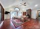 Bright living room features vaulted ceiling, brick fireplace, wood floors, and ample natural light at 965 Hunting Ave, Lincolnton, NC 28092