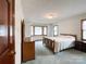 Spacious bedroom features a bay window, patterned wallpaper, and carpeted floors at 965 Hunting Ave, Lincolnton, NC 28092