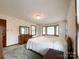 Bright main bedroom with a large bed, dresser, and bay window with lots of light at 965 Hunting Ave, Lincolnton, NC 28092