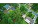 A bird's eye shot reveals a home and neighborhood lush with trees and green space at 9818 Starwood Dr, Charlotte, NC 28215
