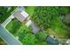 A high angle shows a home with mature trees and landscaping, including a full driveway and sidewalks at 9818 Starwood Dr, Charlotte, NC 28215