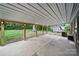 Spacious covered back patio with concrete flooring, wood posts, and an outdoor shed overlooking the backyard at 9818 Starwood Dr, Charlotte, NC 28215