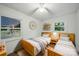 Cozy bedroom with two twin beds, wood floors, and natural light at 9818 Starwood Dr, Charlotte, NC 28215