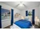 Cozy bedroom features a twin bed, white trim, hardwood floors, and blue curtains allowing for natural light at 9818 Starwood Dr, Charlotte, NC 28215