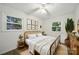 Charming bedroom featuring a full-sized bed, hardwood floors, neutral walls, a ceiling fan, and natural light at 9818 Starwood Dr, Charlotte, NC 28215