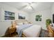 Bright bedroom showcasing a queen-sized bed, hardwood floors, neutral walls, and ample natural light at 9818 Starwood Dr, Charlotte, NC 28215