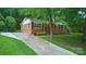 Lovely one-story brick home showcasing a cozy front entrance and well-maintained landscaping at 9818 Starwood Dr, Charlotte, NC 28215