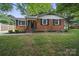 Inviting brick home with lush green lawn and well-maintained front yard at 9818 Starwood Dr, Charlotte, NC 28215