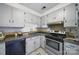 The kitchen is finished with a stainless steel oven and ample cabinet storage at 9818 Starwood Dr, Charlotte, NC 28215