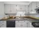 A well lit kitchen is finished with dark countertops, updated appliances, and ample cabinets at 9818 Starwood Dr, Charlotte, NC 28215