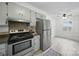 The bright kitchen features a stainless steel refrigerator and direct access to the dining area at 9818 Starwood Dr, Charlotte, NC 28215