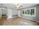 Bright living room featuring wood floors and large windows, and a ceiling fan at 9818 Starwood Dr, Charlotte, NC 28215