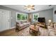Living room with stylish decor, hardwood flooring, and abundant natural light at 9818 Starwood Dr, Charlotte, NC 28215