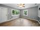 Bright living room featuring hardwood flooring, neutral paint and ceiling fan at 9818 Starwood Dr, Charlotte, NC 28215