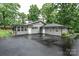 Home's exterior with attached sunroom and detached garage on an ample paved driveway at 1035 15Th Nw Ave, Hickory, NC 28601
