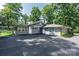 Back exterior with an expansive blacktop parking area at 1035 15Th Nw Ave, Hickory, NC 28601