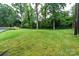 Large back yard with lush green grass and large trees at 1035 15Th Nw Ave, Hickory, NC 28601