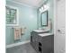 Stylish bathroom with a modern vanity, gray cabinets, marble countertop, and a rectangular mirror at 1035 15Th Nw Ave, Hickory, NC 28601