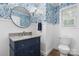 Elegant powder room with floral wallpaper, wainscoting, granite sink and a round mirror at 1035 15Th Nw Ave, Hickory, NC 28601