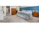 Well-lit bedroom with carpet flooring, blue accent wall, dresser, nightstand, and a walk-in closet at 1035 15Th Nw Ave, Hickory, NC 28601