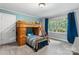 Charming bedroom featuring bunk beds, natural light from a window and a light blue accent wall at 1035 15Th Nw Ave, Hickory, NC 28601
