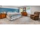 Cozy bedroom features a plush carpet, queen-size bed, wood furniture, and plenty of natural light at 1035 15Th Nw Ave, Hickory, NC 28601