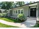 Charming home entrance with a black door, brick facade, and tidy landscaping at 1035 15Th Nw Ave, Hickory, NC 28601