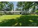 Beautifully landscaped front yard of a single-story home with mature trees at 1035 15Th Nw Ave, Hickory, NC 28601