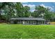 Charming gray single story house with green front lawn and plenty of mature trees in the background at 1035 15Th Nw Ave, Hickory, NC 28601
