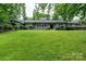 Charming brick home features a large lawn, updated windows, and mature landscaping at 1035 15Th Nw Ave, Hickory, NC 28601