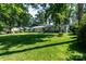 Manicured lawn with mature trees surrounds a charming home with a classic gray exterior at 1035 15Th Nw Ave, Hickory, NC 28601