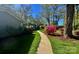 Well-manicured yard with mature tree and colorful flowerbeds at 1035 15Th Nw Ave, Hickory, NC 28601