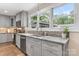 Renovated kitchen with gray cabinetry, mosaic backsplash, granite counters, and stainless steel appliances at 1035 15Th Nw Ave, Hickory, NC 28601
