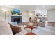 Bright living room features a brick fireplace, hardwood floors, and neutral-toned furniture at 1035 15Th Nw Ave, Hickory, NC 28601