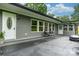 Exterior patio area with gray concrete floor and gray siding, with views of the front and back yard at 1035 15Th Nw Ave, Hickory, NC 28601