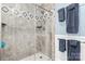 Walk-in shower with gray tiling, glass doors, and towel rack at 1035 15Th Nw Ave, Hickory, NC 28601