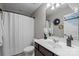 Well-lit bathroom featuring a vanity, toilet, mirror, and shower with a clean, white shower curtain at 1035 Ivey Ct, Indian Land, SC 29707