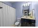 Charming full bathroom features a shower with a white curtain, modern vanity with cabinet, and soft blue walls at 1035 Ivey Ct, Indian Land, SC 29707