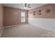 Bedroom features a neutral wall color, white wainscoting, and a ceiling fan with carpet floors at 1035 Ivey Ct, Indian Land, SC 29707