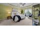 This primary bedroom has a tray ceiling, ceiling fan, and windows with lots of natural light at 1035 Ivey Ct, Indian Land, SC 29707
