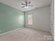 Simple bedroom featuring wall-to-wall carpeting, natural light, ceiling fan, and a calming color scheme at 1035 Ivey Ct, Indian Land, SC 29707