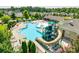 Aerial view of community pool featuring a splash pad, slide, lounge chairs, and clubhouse at 1035 Ivey Ct, Indian Land, SC 29707