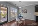 Bright dining area with a glass table set, stylish decor, and backyard access with lots of natural light at 1035 Ivey Ct, Indian Land, SC 29707