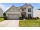 Charming two-story home with landscaped yard and an attached two-car garage at 1035 Ivey Ct, Indian Land, SC 29707