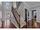 Bright foyer features hardwood floors, a staircase, and a view of the front door with sidelights at 1035 Ivey Ct, Indian Land, SC 29707