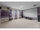 Large home theater features a projector screen, neutral carpet, and theater sound system at 1035 Ivey Ct, Indian Land, SC 29707